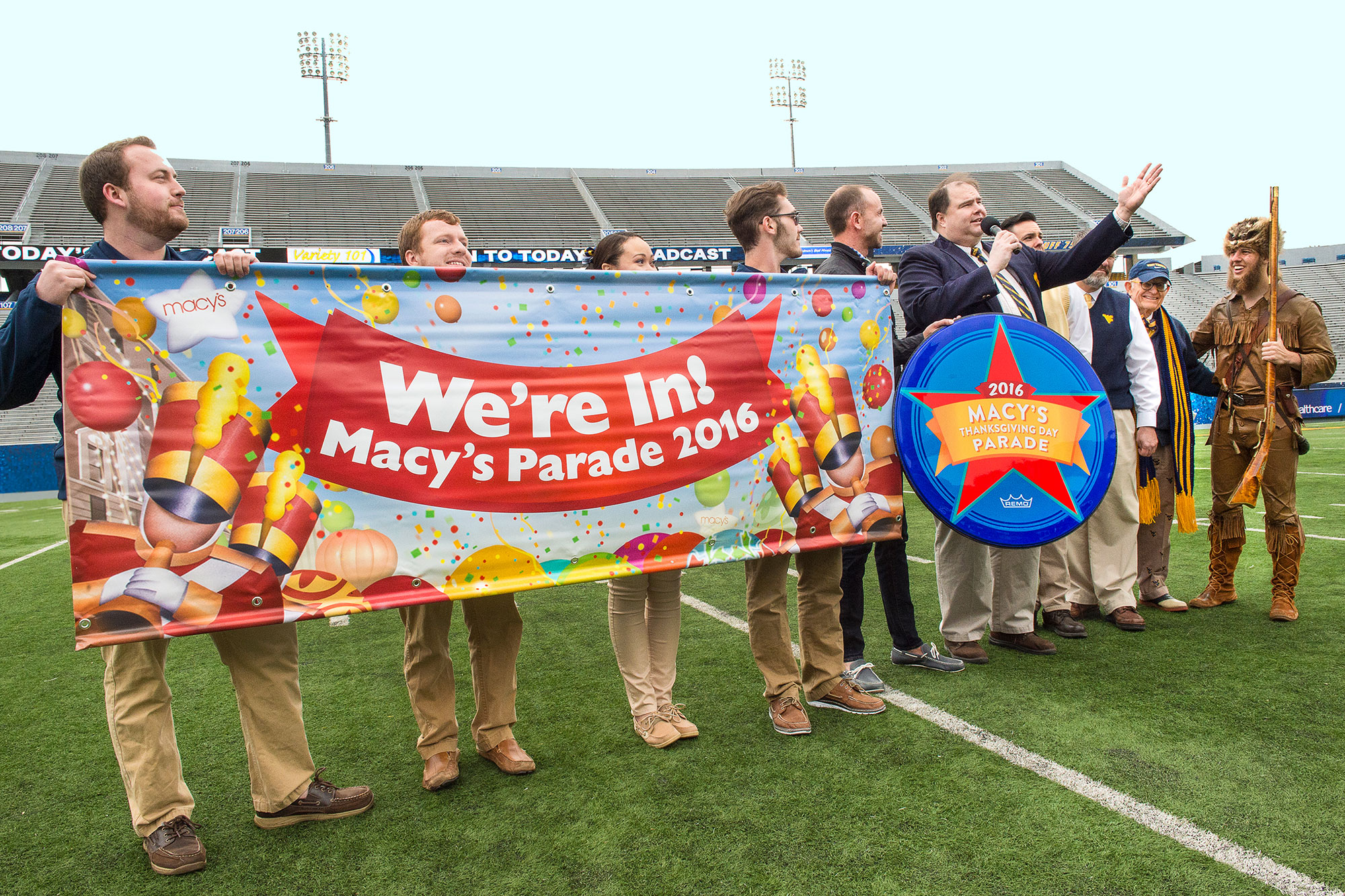 WVU Band holding a banner