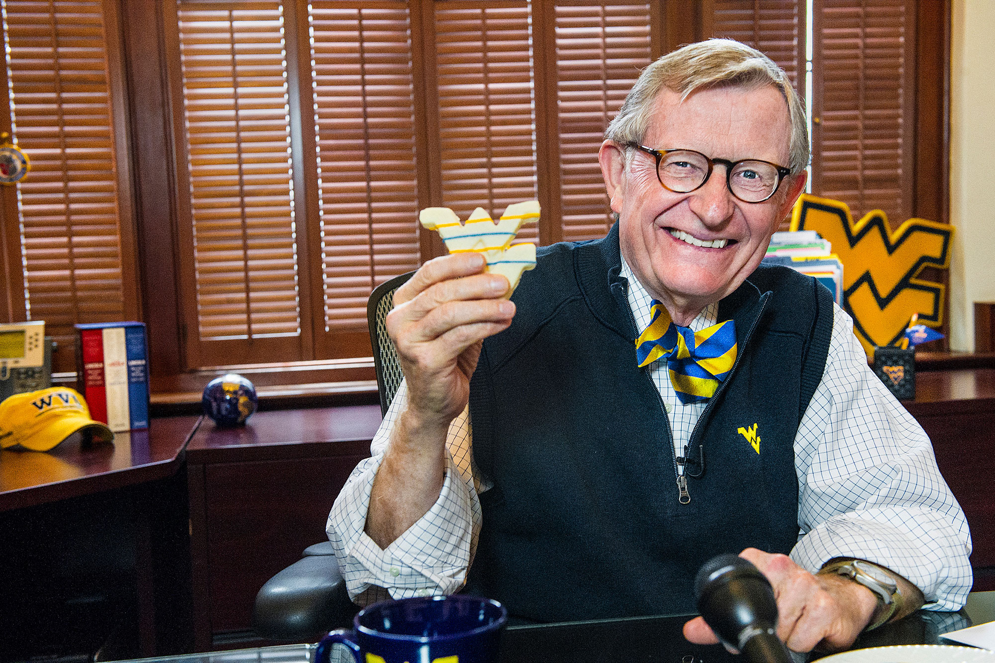 President Gee holding a cookie